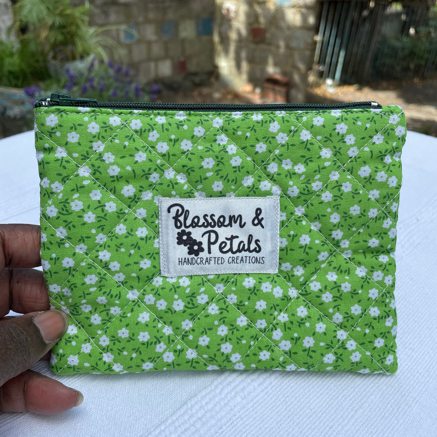 Green floral fabric with a visible brand label on a white surface