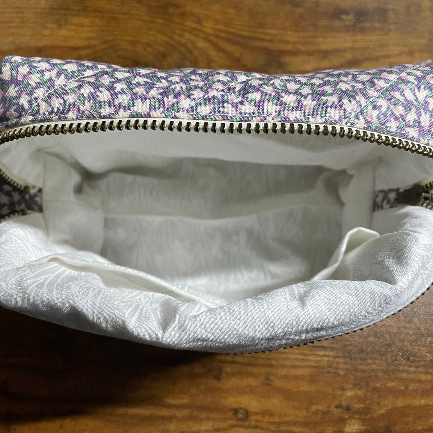 Small pouch with floral pattern on a wooden surface