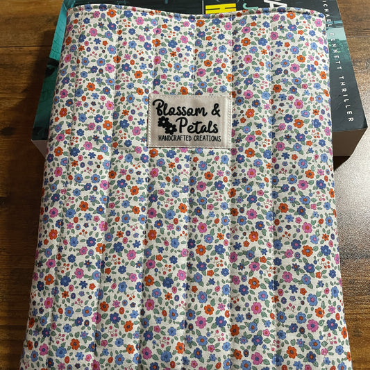 Floral-patterned fabric with a brand label on a wooden surface