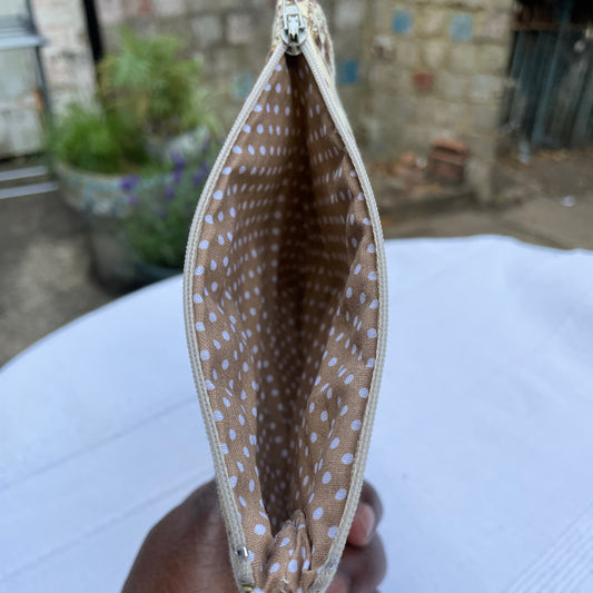 Beige Floral pattern with a polka dot lining pouch with a blurred background