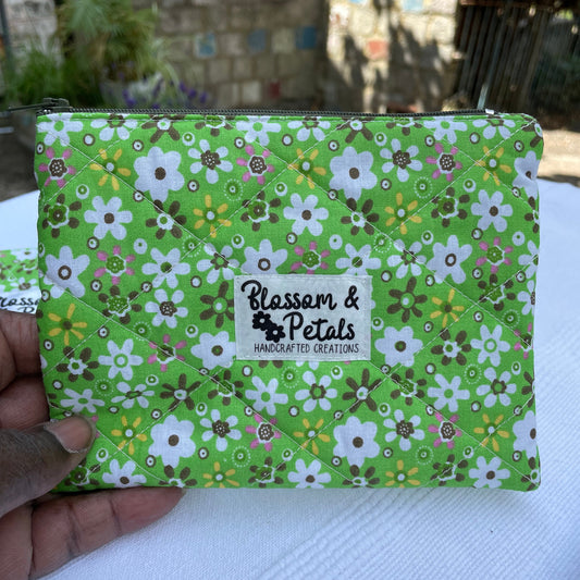Green floral-patterned product with a visible brand logo held by a hand.
