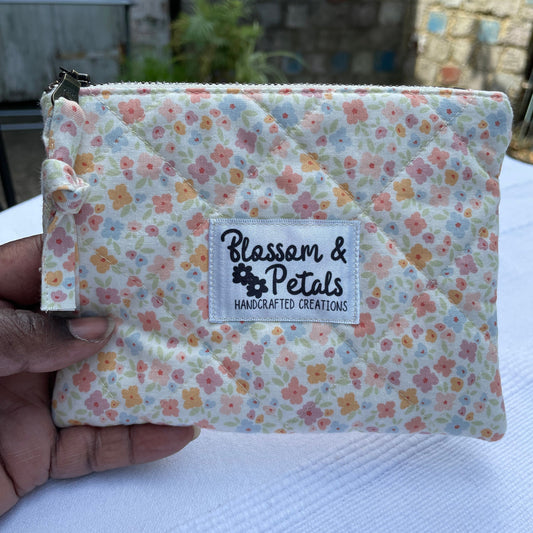 Floral-patterned product with a visible brand label held by a hand against a blurred background.