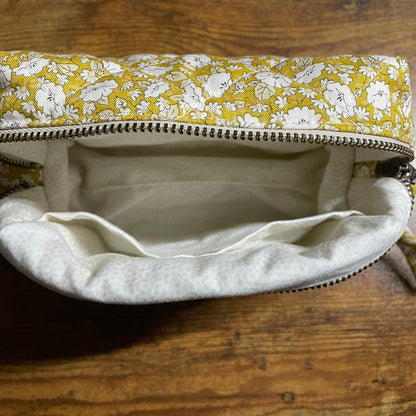 Small pouch with floral pattern on a wooden surface