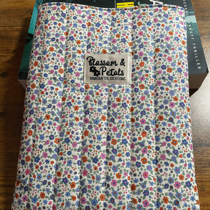 Floral-patterned fabric with a brand label on a wooden surface