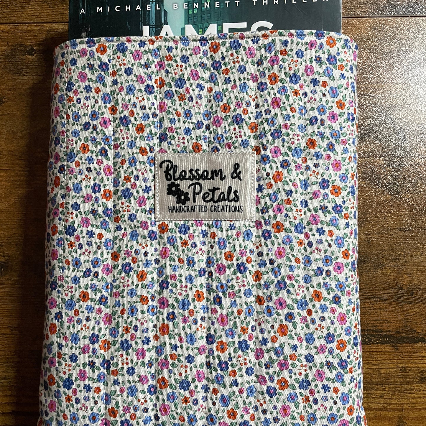Floral patterned product with 'Blossom & Petals' label on a wooden surface