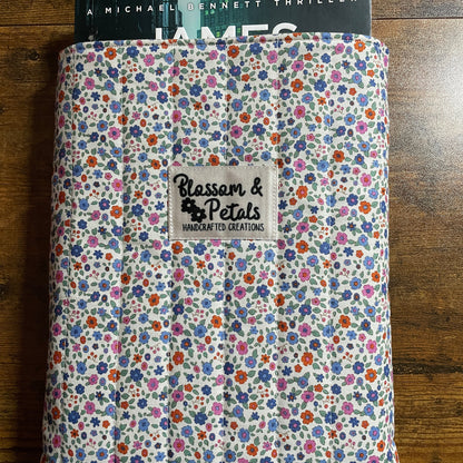 Floral patterned product with 'Blossom & Petals' label on a wooden surface