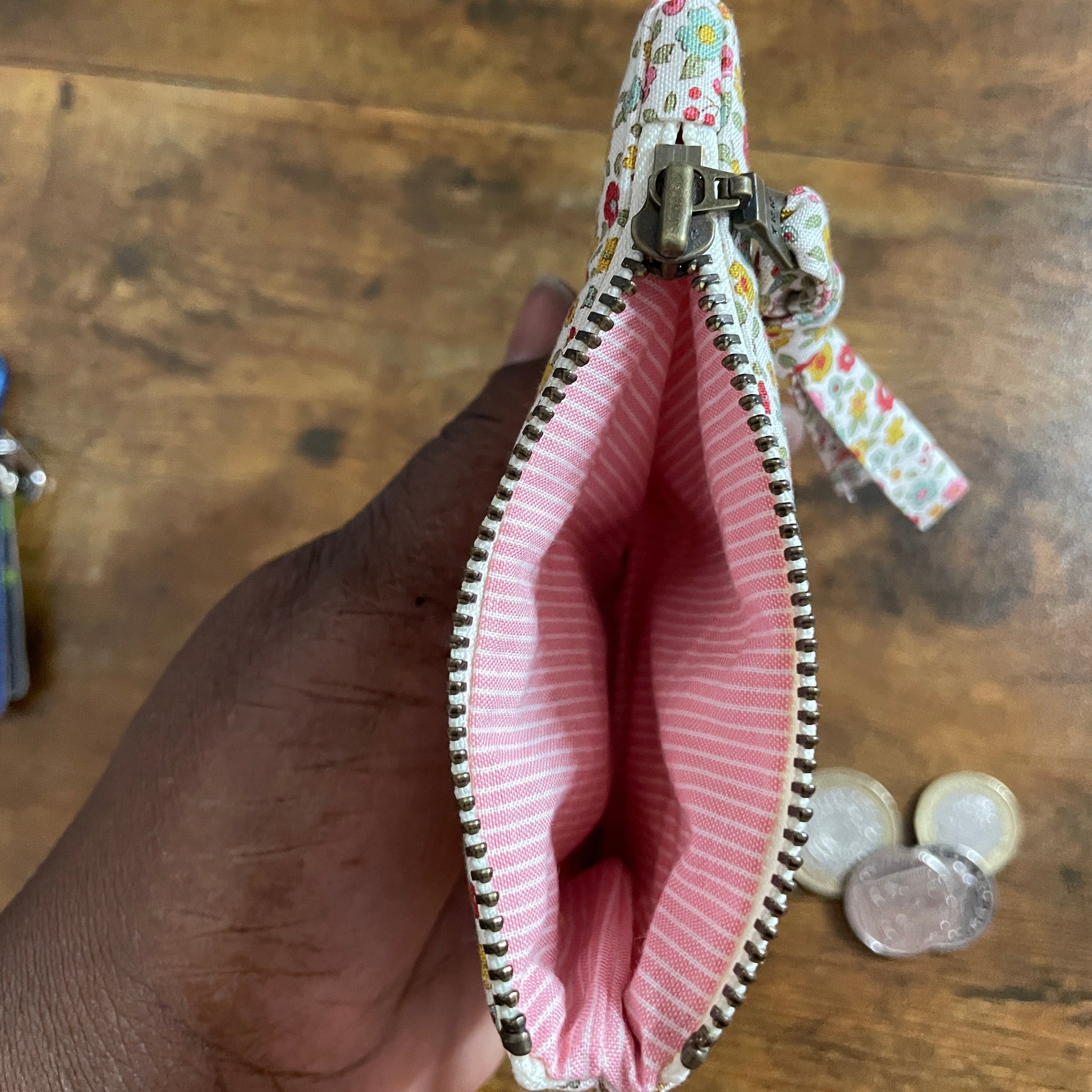 Handmade floral quilted zipper pouch in cotton fabric with pink stripe lining fabric, ideal as a coin purse, small makeup bag, or everyday accessory pouch