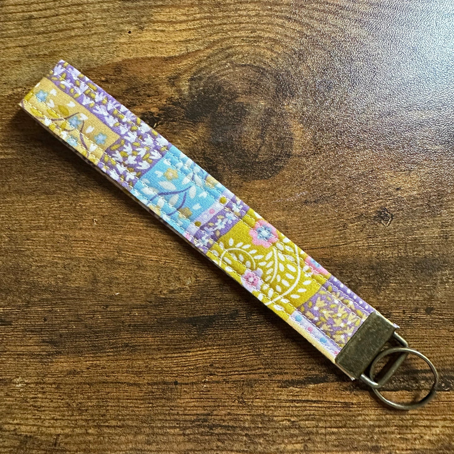 Patterned key fob on a wooden surface