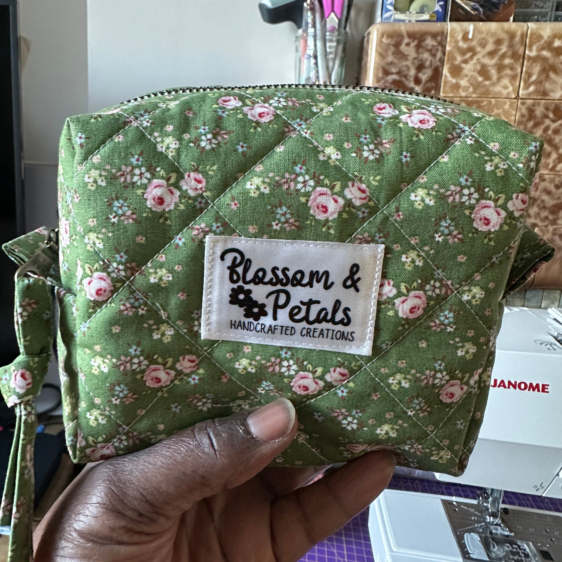Handmade green floral quilted makeup bag with zip closure, cotton cosmetic pouch sewn with vintage style floral fabric, perfect for makeup storage and travel organisation.