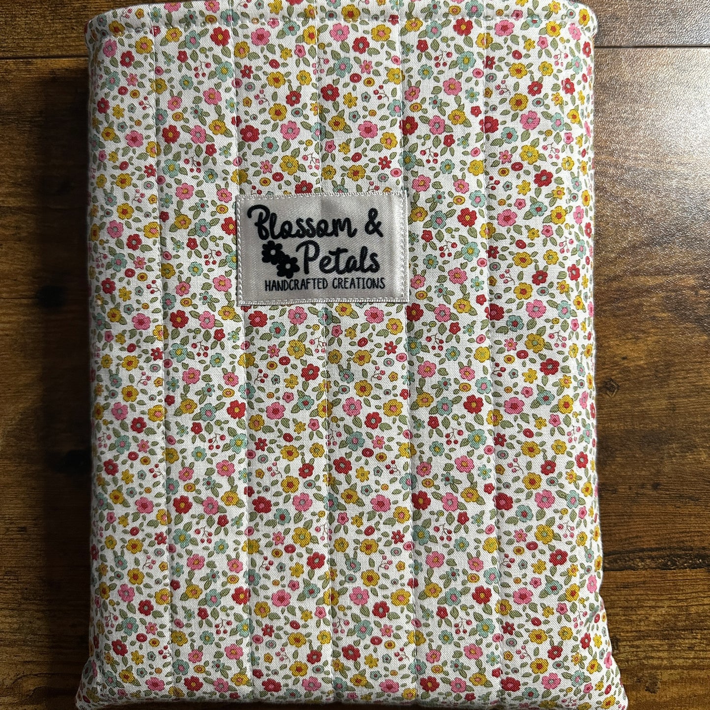 Handmade small floral padded fabric book sleeve protecting books and journals